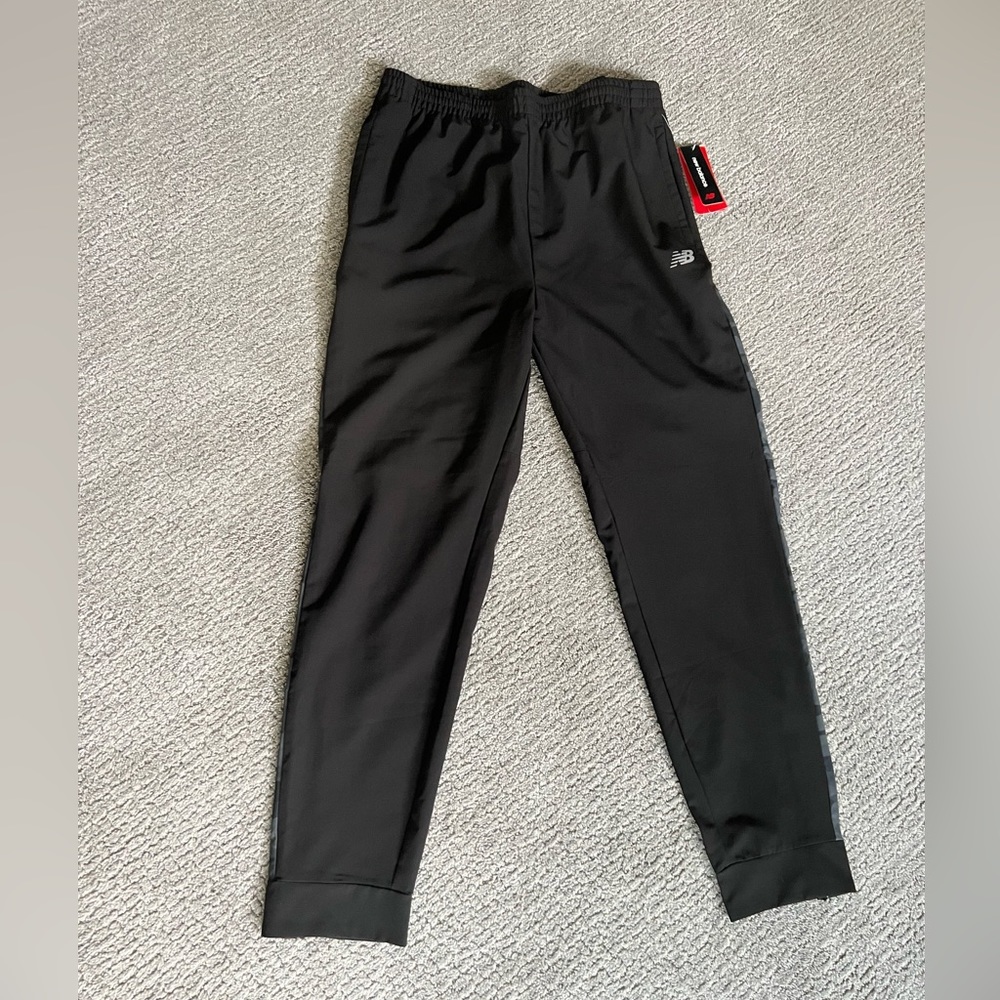 NWT, Mens New Balance joggers, black with camo accent on back.